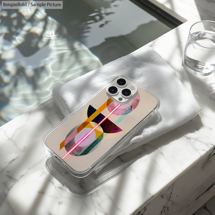 Modern smartphone with abstract geometric case on marble surface by pool.