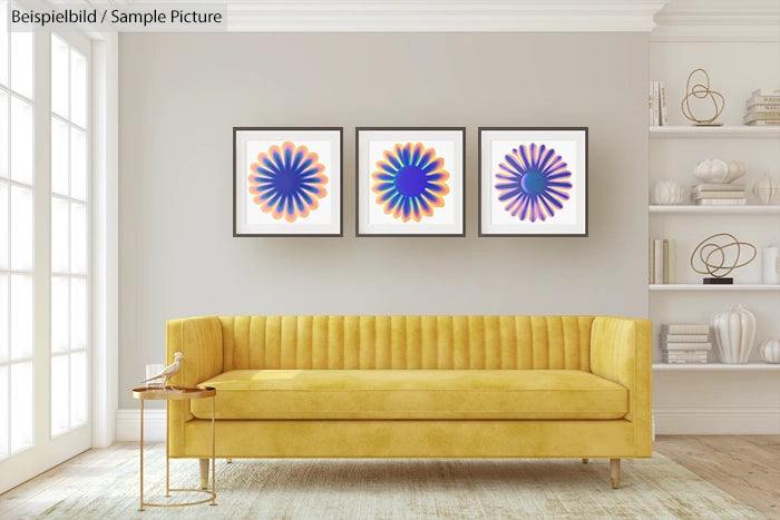 Modern living room with yellow sofa and three abstract floral paintings on wall.