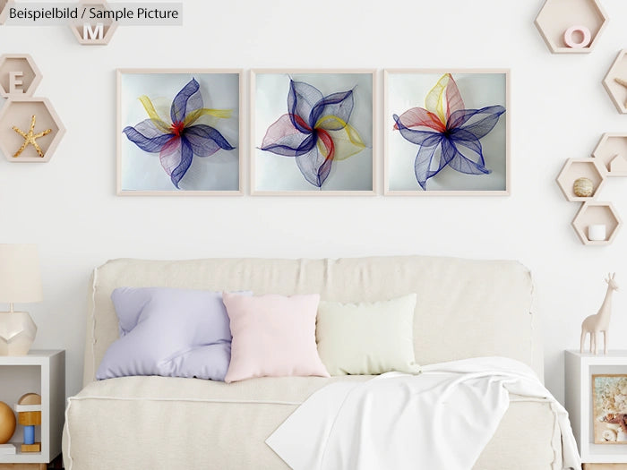 Living room with a beige sofa, pastel pillows, and three colorful abstract flower artworks on the wall.