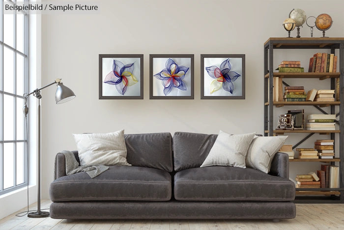 Contemporary living room with a grey sofa, three abstract flower paintings, and a bookshelf with books and decor items.