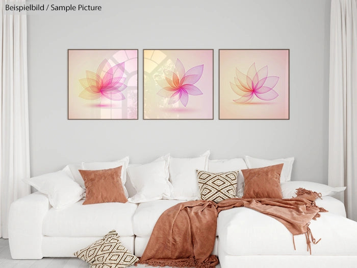 Modern living room with white sofa, brown pillows, and three abstract flower artworks on the wall.