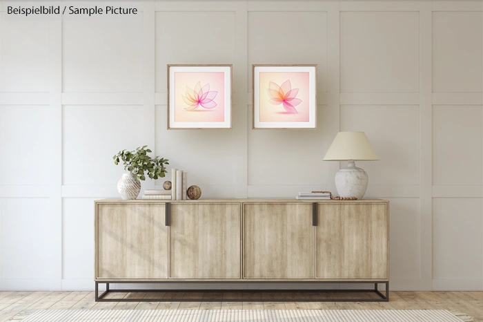Modern living room with wooden sideboard, decorative vases, and two framed flower artworks on a white panel wall.