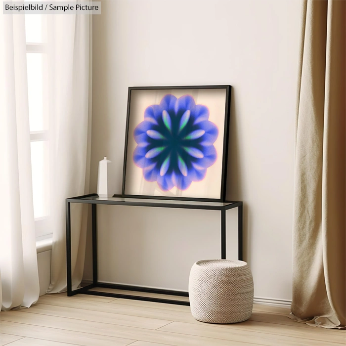 Framed abstract flower artwork on a modern console table in a minimalist room with neutral curtains and decor.