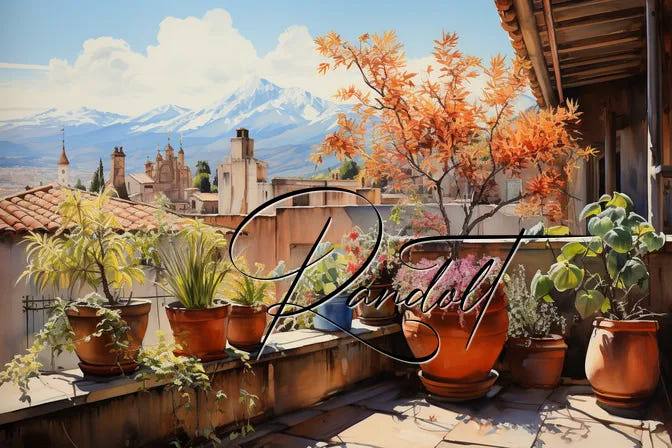 Terrace with potted plants, autumn foliage, and view of church towers against snow-capped mountains and blue sky.