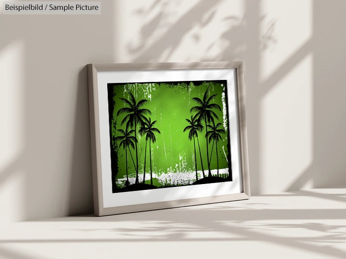 Framed artwork of palm trees on a vibrant green background, leaning against a sunlit wall.