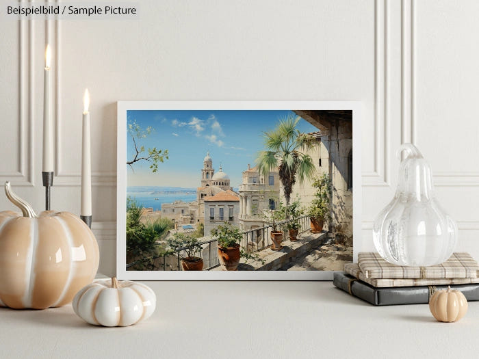 Coastal cityscape photo in frame on elegant table with pumpkins, candles, and glass vase in chic interior.