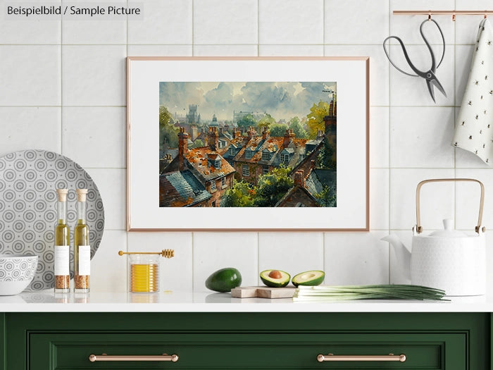 Kitchen interior with framed painting of a village scene, featuring red roofs and greenery, hanging on a white tiled wall.