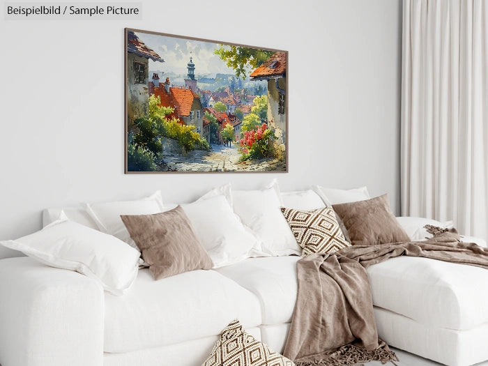 Modern living room with white sofa, brown pillows, and a painting of a quaint village on the wall.
