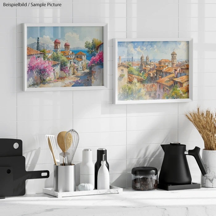 Kitchen decor with framed landscape art, utensils in a holder, and a black kettle on a white-tiled backsplash.