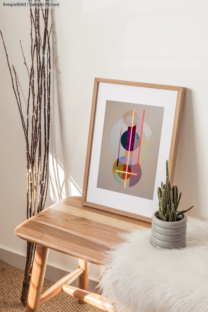 Minimalist room with abstract art, wooden bench, branches, and potted cactus.