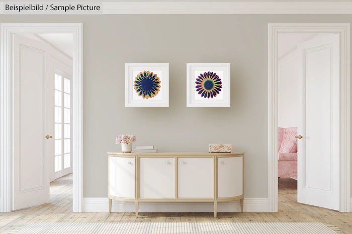 Minimalist living room with two flower art prints above a sleek sideboard.