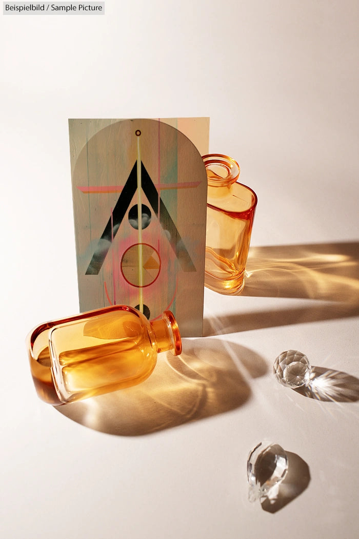 Two amber glass bottles, abstract geometric artwork, and crystal spheres casting shadows on a white background.