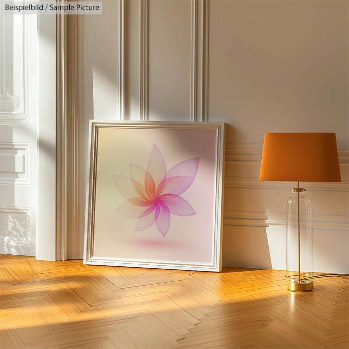 Framed floral artwork with pink petals on the floor, next to a modern lamp in sunlit room with wooden flooring.